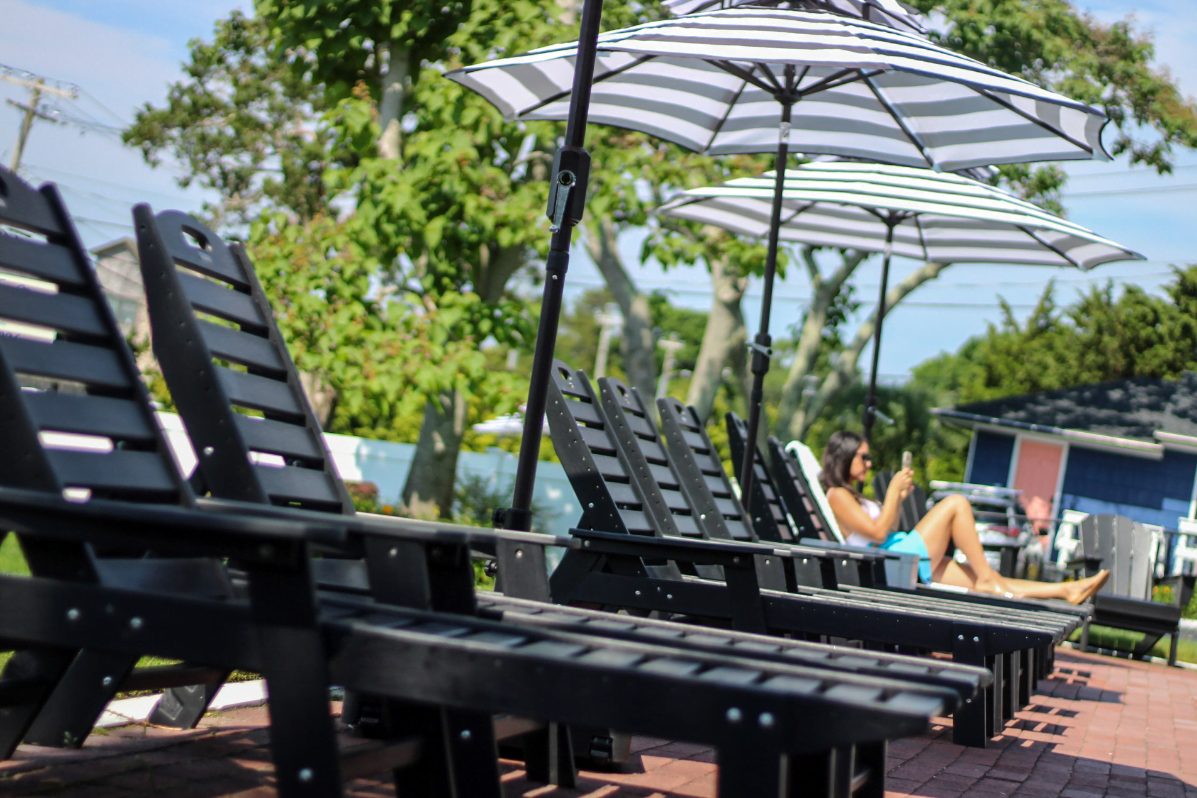 Ocean View Terrace Inn parking area with mature trees