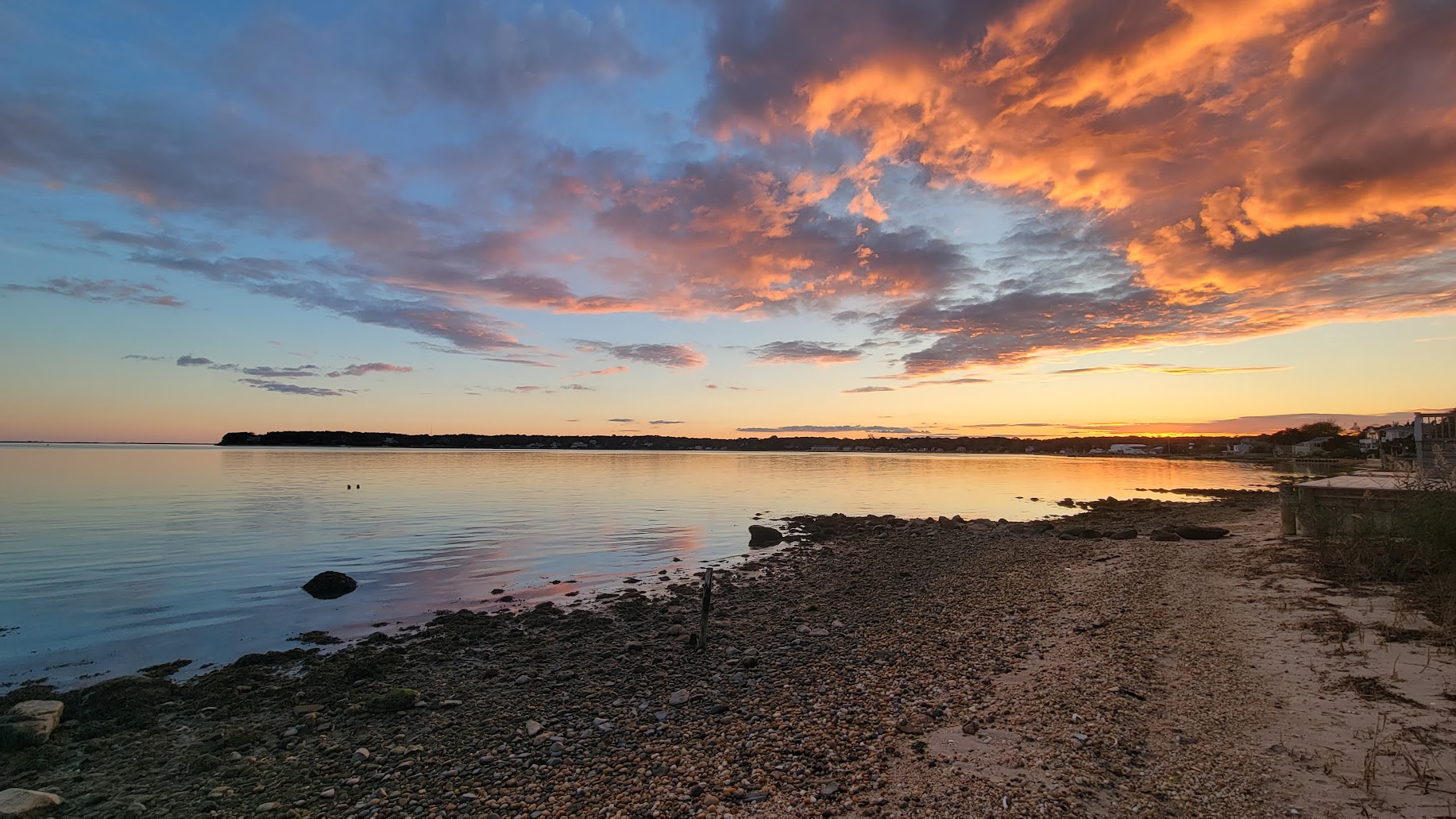 Ocean View Terrace Inn exterior at golden hour with flowers in bloom